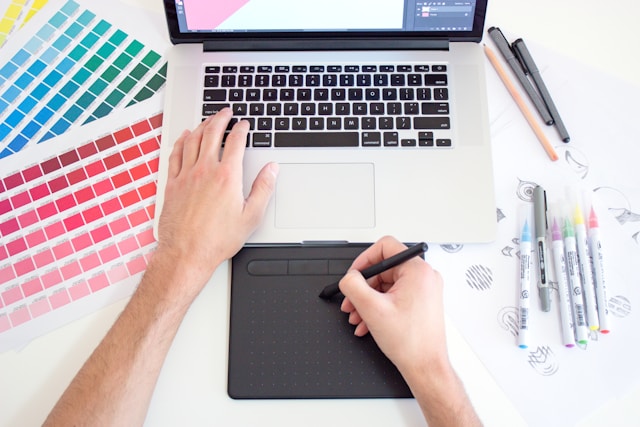 man drawing on a graphics tablet
